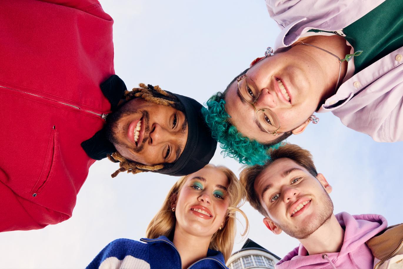 Four young people smiling at the camera